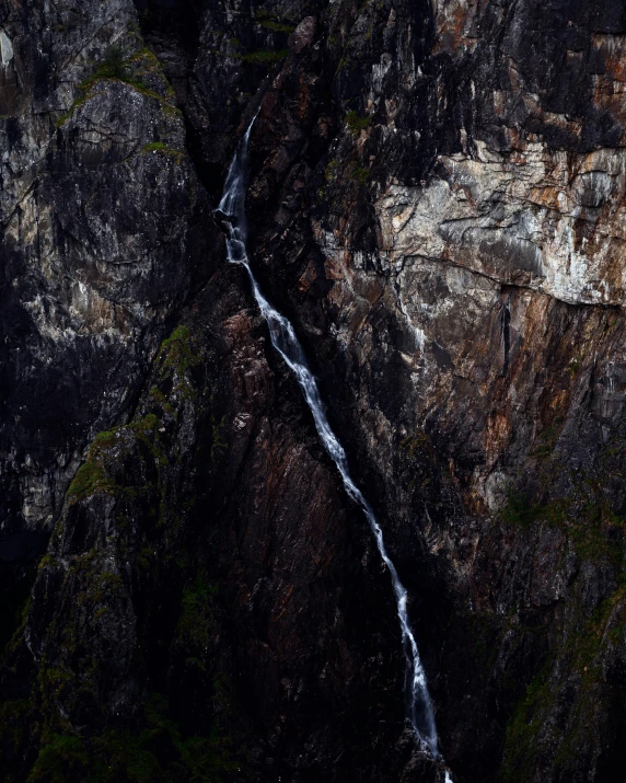 a waterfall cascades down a mountain side, in this po