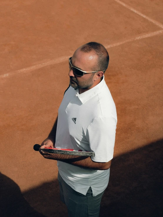 a tennis player standing on the tennis court holding a racket