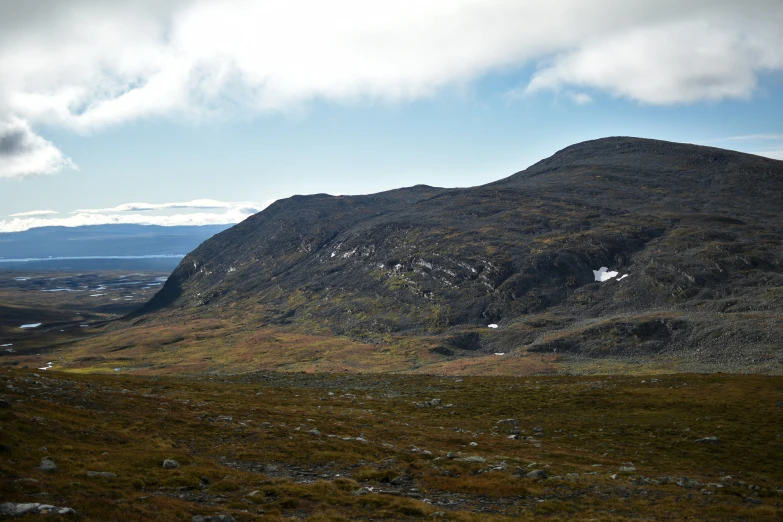 the small mountains with rocky terrain are covered in moss