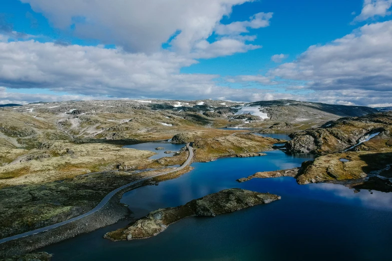 aerial view of small body of water near mountains