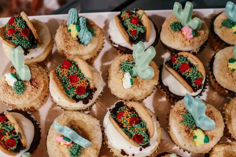 a box filled with cupcakes covered in frosting