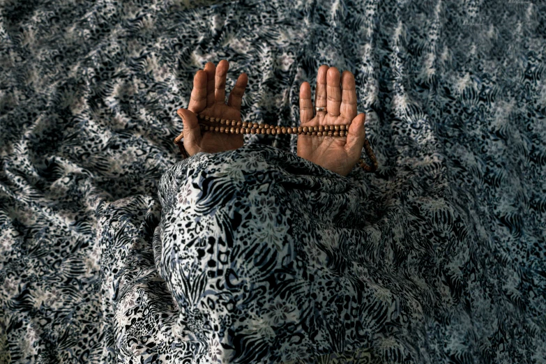 a man's hand resting on the back of a couch