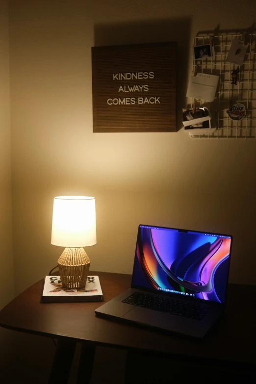 a laptop computer on a desk in a corner