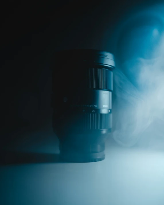 a black lens with some fog in the background