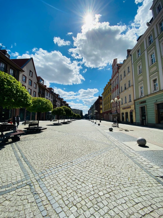 a large paved street that leads to buildings