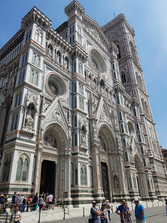 a cathedral with elaborate architecture next to people