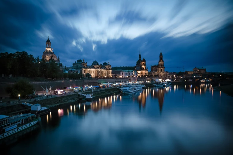 a few boats sit in the water near some buildings