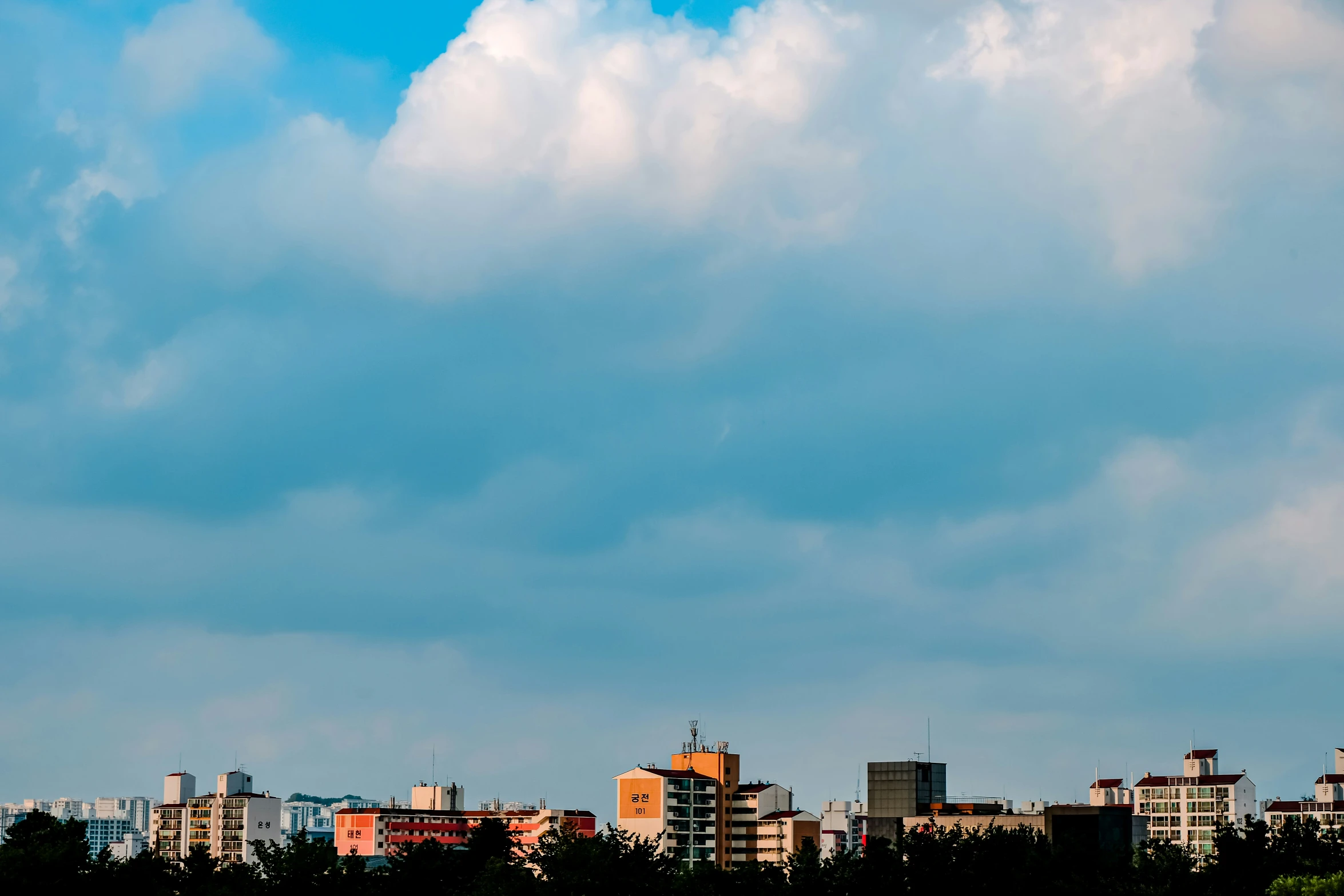 a po of the sky with some clouds and a plane in the air