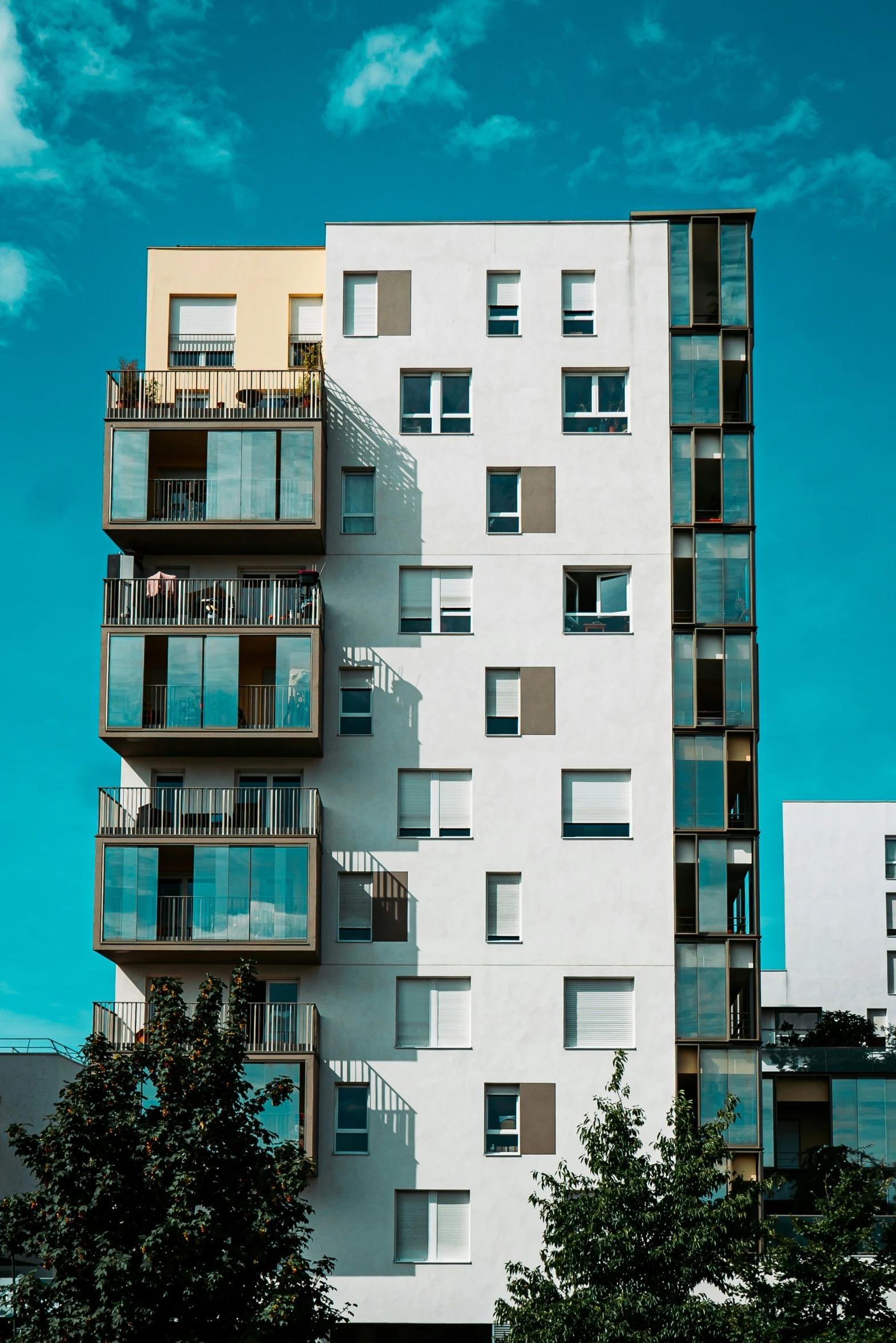 tall white building with balconies and balconies on the side