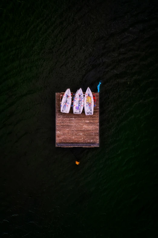 a couple of people on the pier with some umbrellas