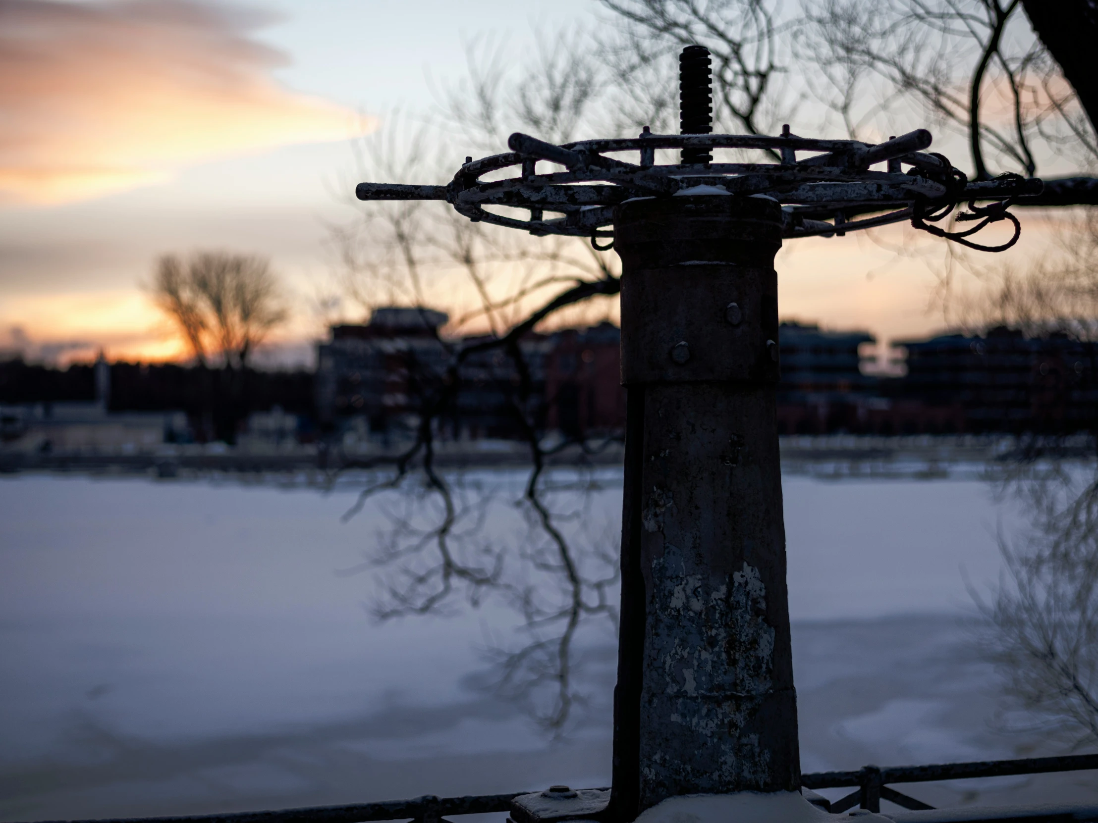 a wooden fence covered with metal barbed wire