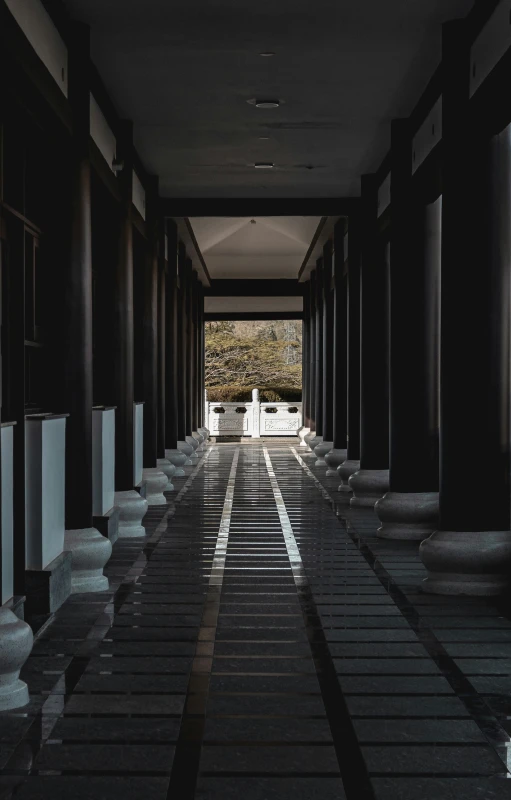 a large hallway that has many pillars and tables