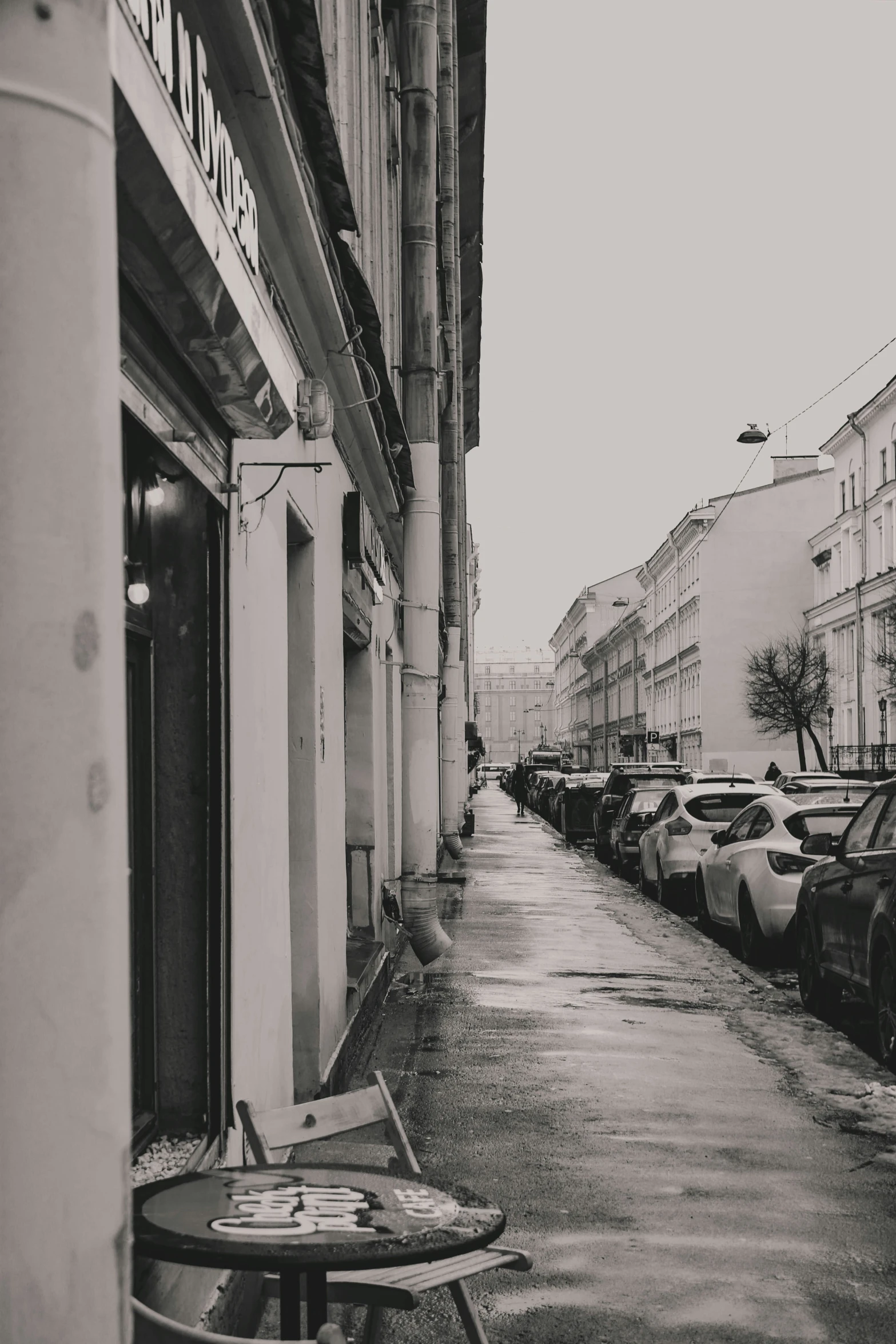 black and white image of sidewalk in city area