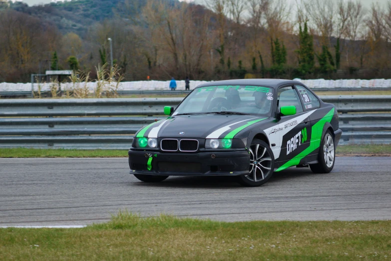 a car driving down the track in the day