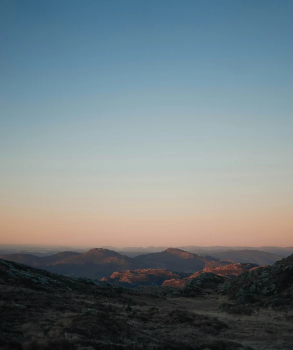 this is a view of some hills at sunset