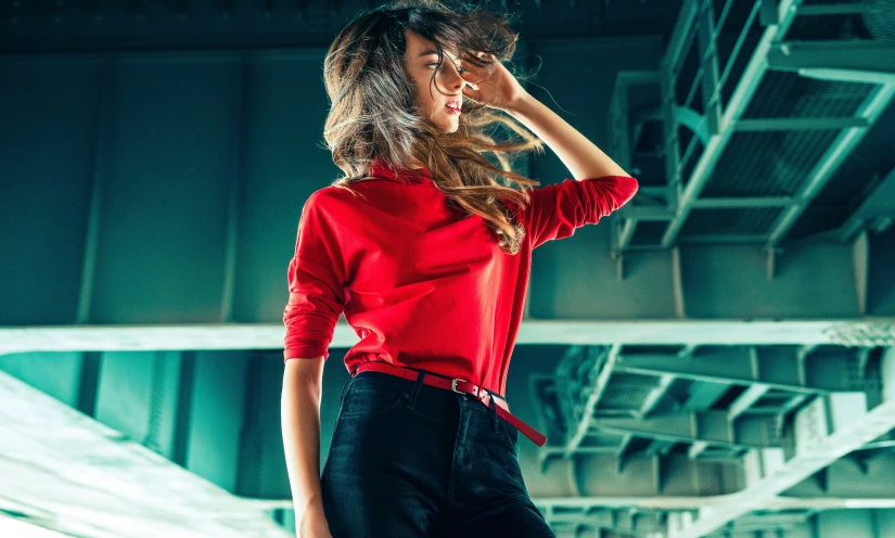 a woman wearing a red shirt and black pants