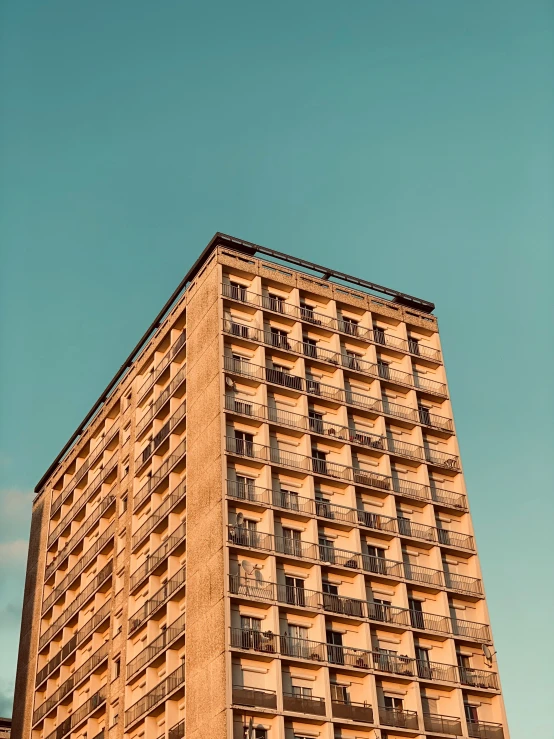 a high rise apartment building towering in the sky