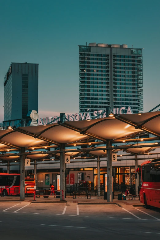 a bus terminal with an airplane in the background