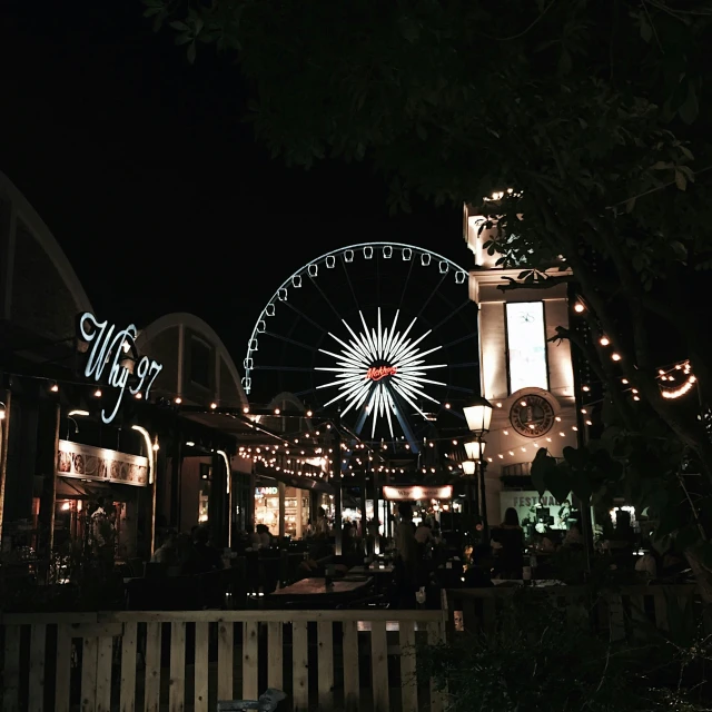 a dark building with lights that look like the ferris wheel