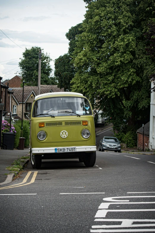 a classic vw van is driving down the street