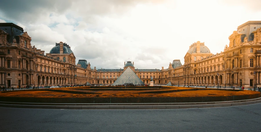 the huge building has a triangle shaped garden on top