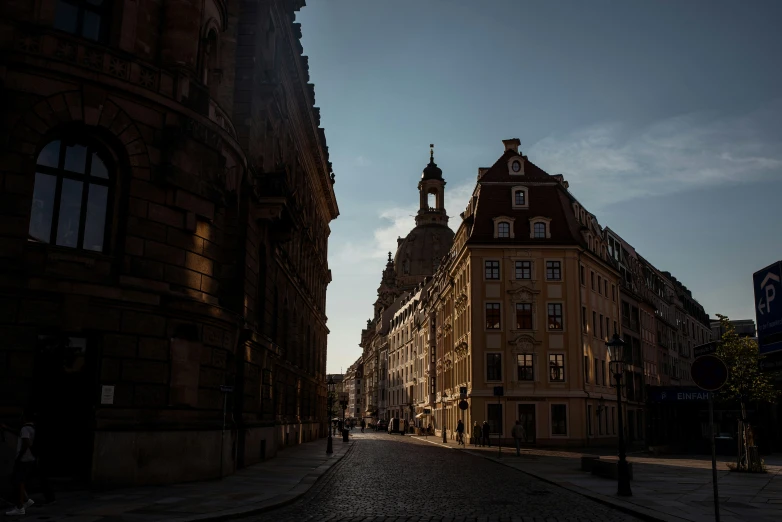 there is a building and a clock tower on the street