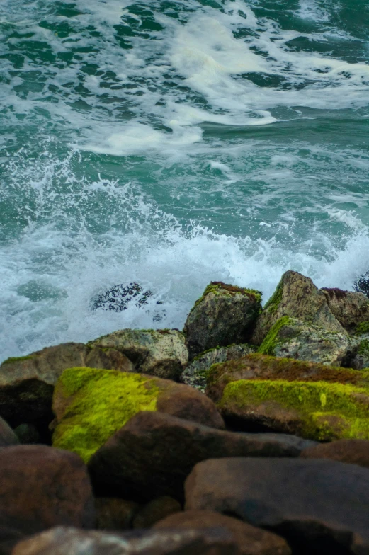 the shore with a wave coming up over it