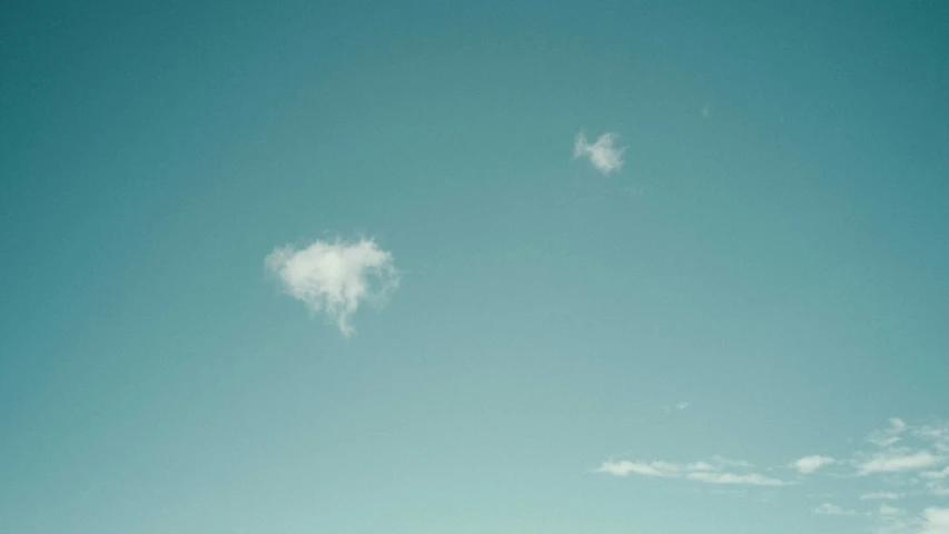 an airplane is flying above some grass and trees