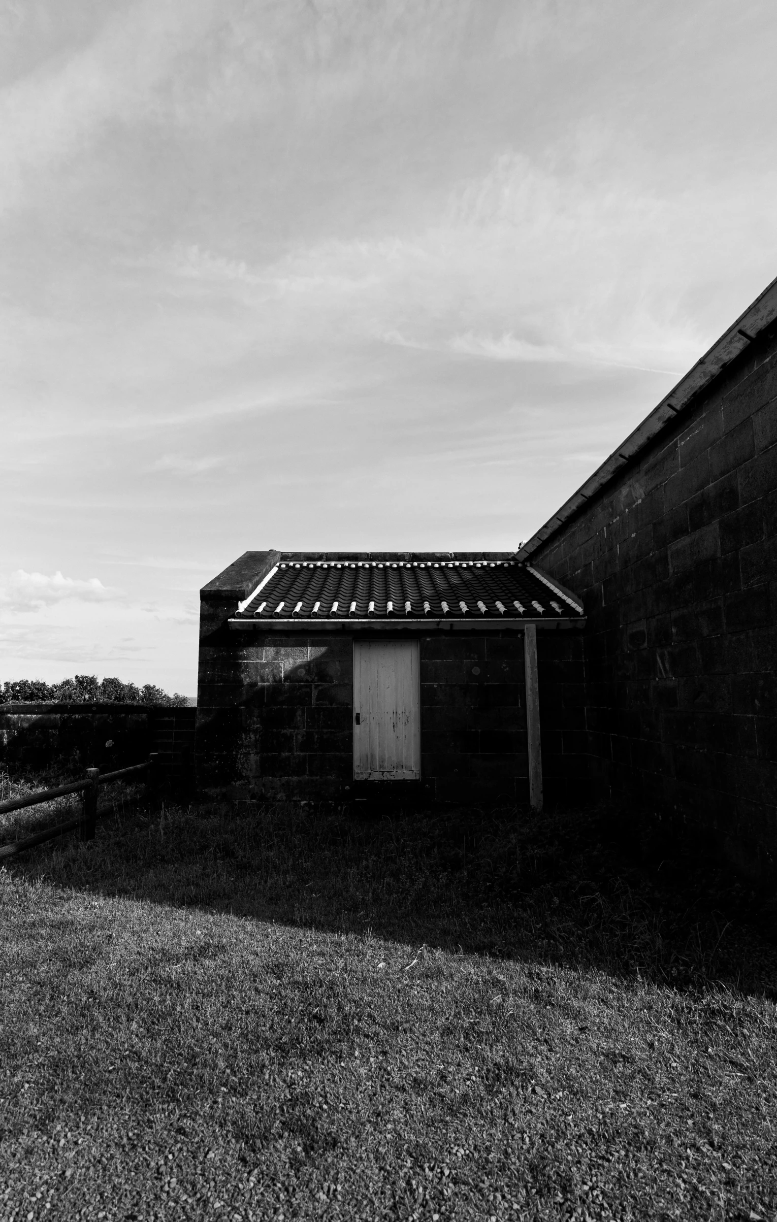 black and white pograph of an old barn on a windy day