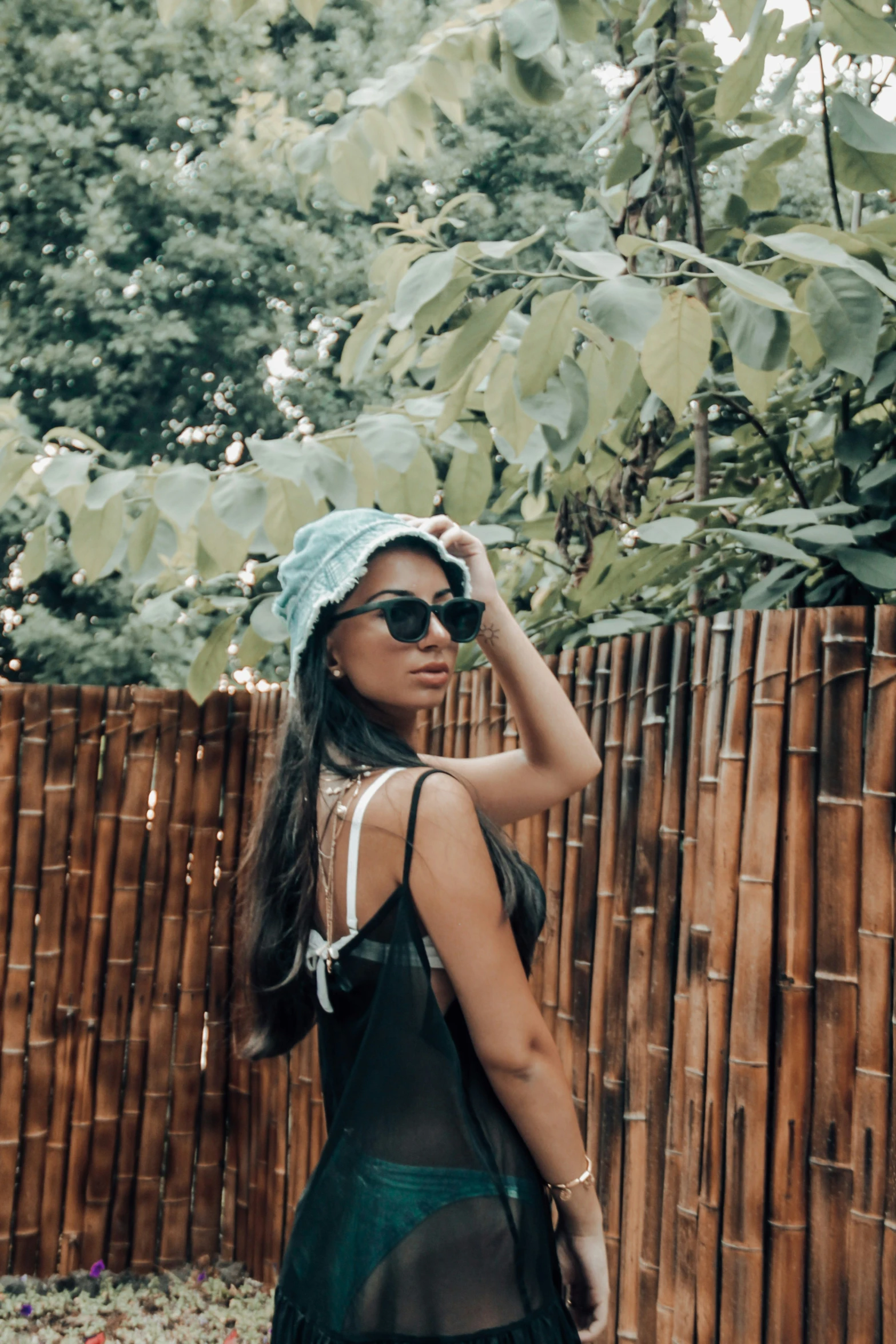 a young woman wearing sunglasses and a blue hat