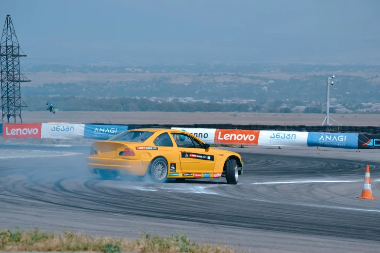 a yellow car making a tight turn on a track