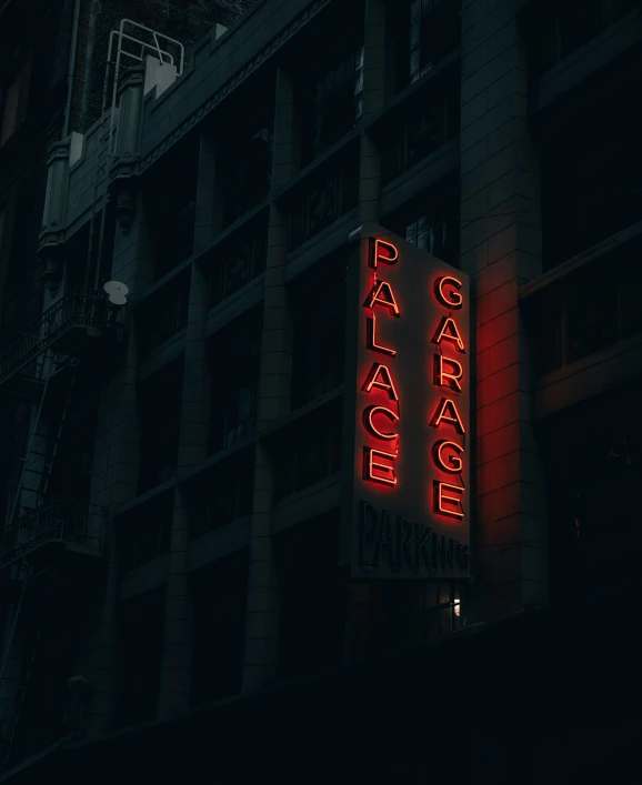 there is an illuminated sign on the side of a building