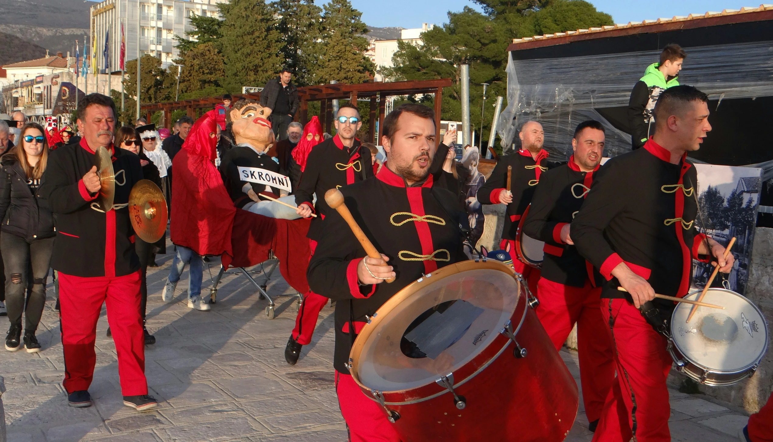 a group of drummers dressed in red marching outfits