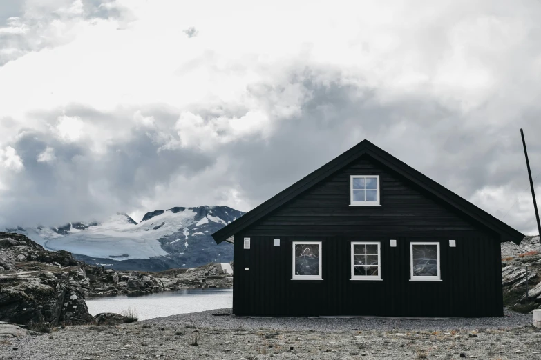 a small house sits on the side of a mountain