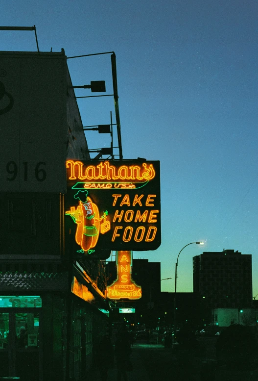 a large neon sign outside of a restaurant