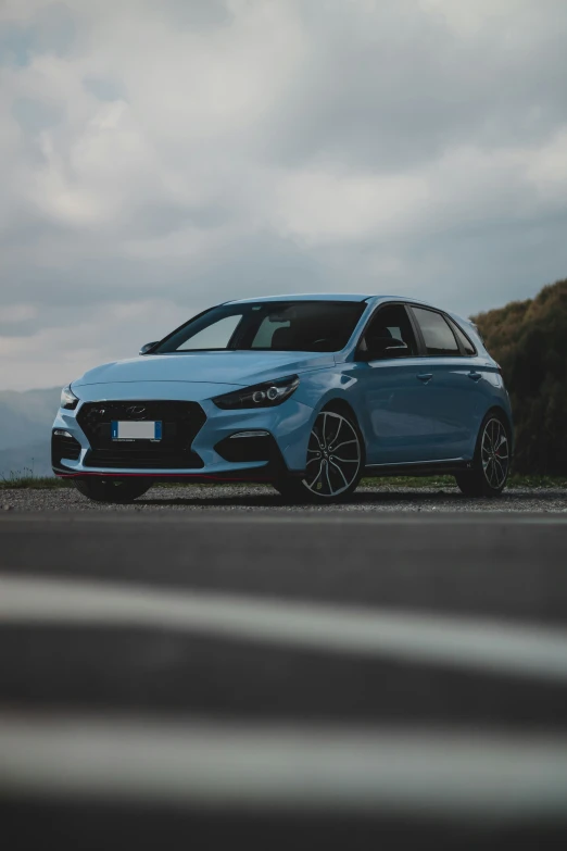 a blue car is parked on the side of the road