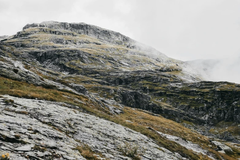 a mountain side with sp grass and rocks