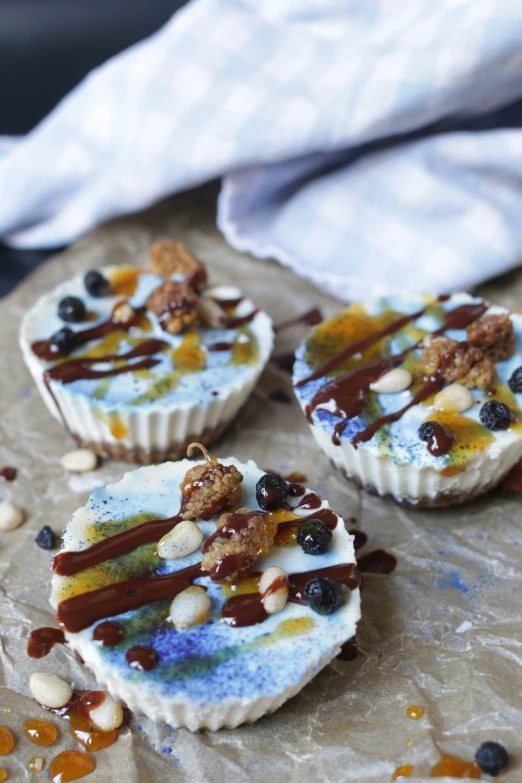 three desserts on wax paper with toppings