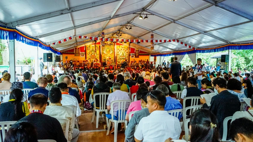 a large group of people sitting in a room