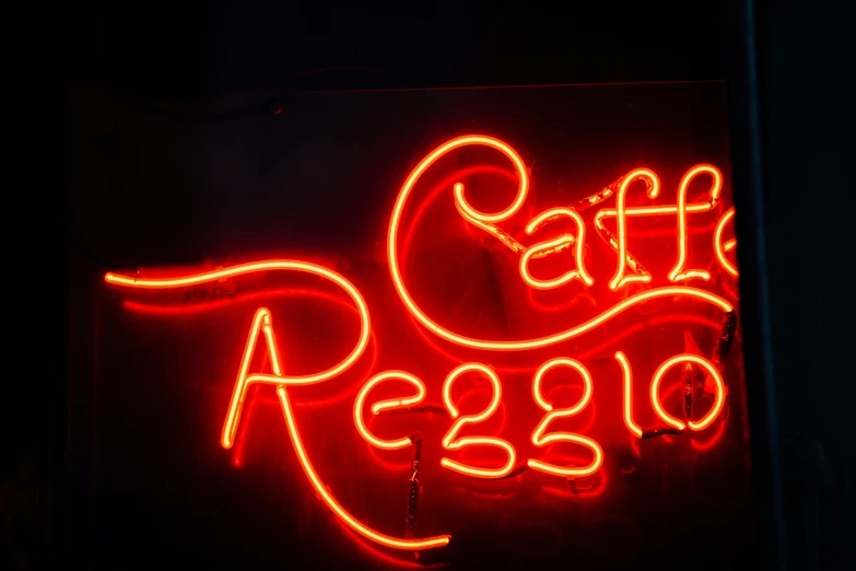 a dark lit sign with a cafe keg underneath it