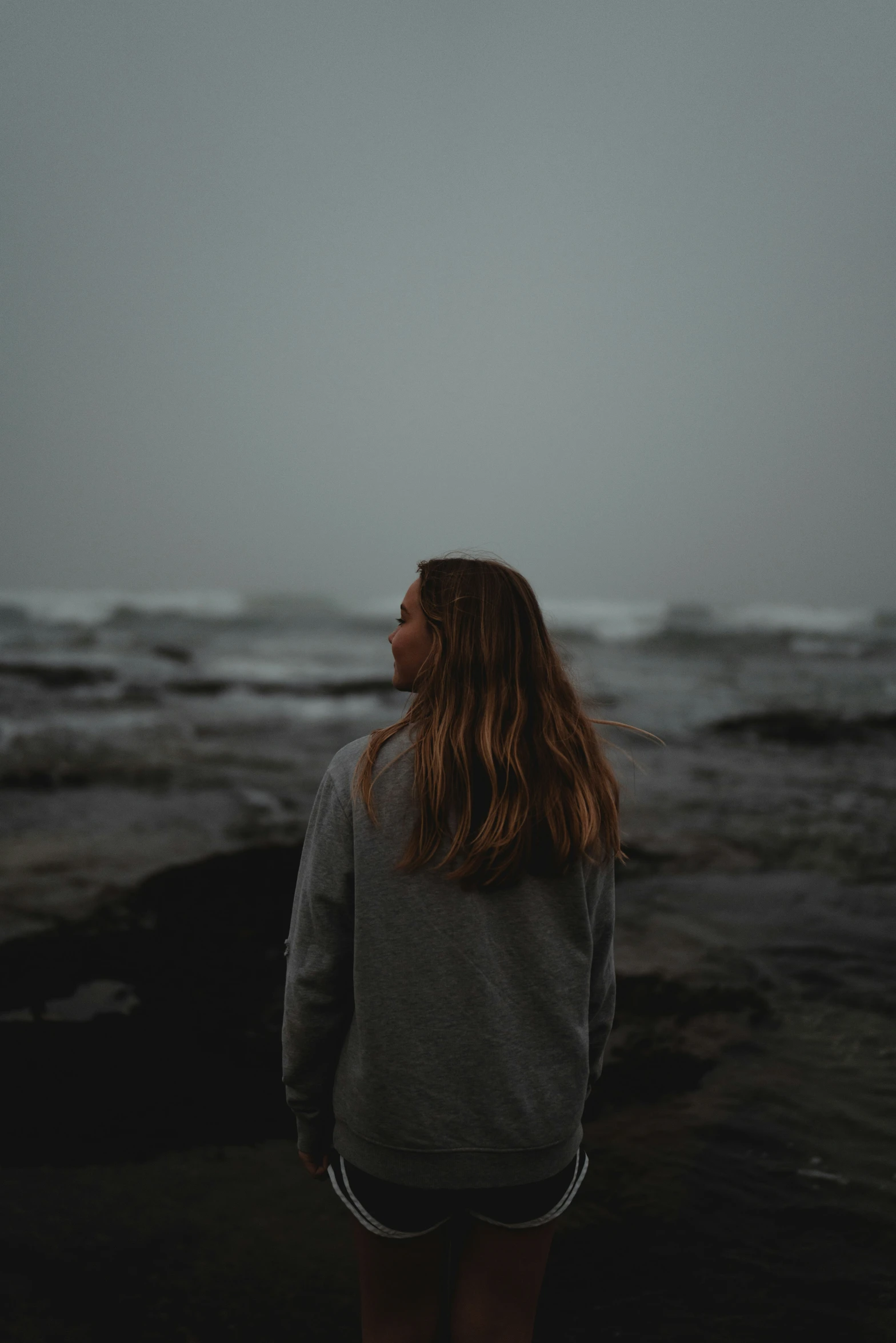 the back of a person standing near the water