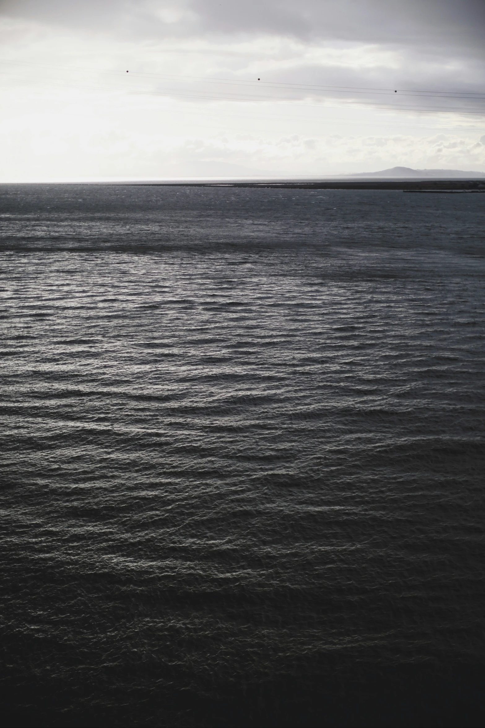 a large body of water with clouds in the sky