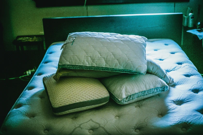 pillows and pillows on a bed in a dark room