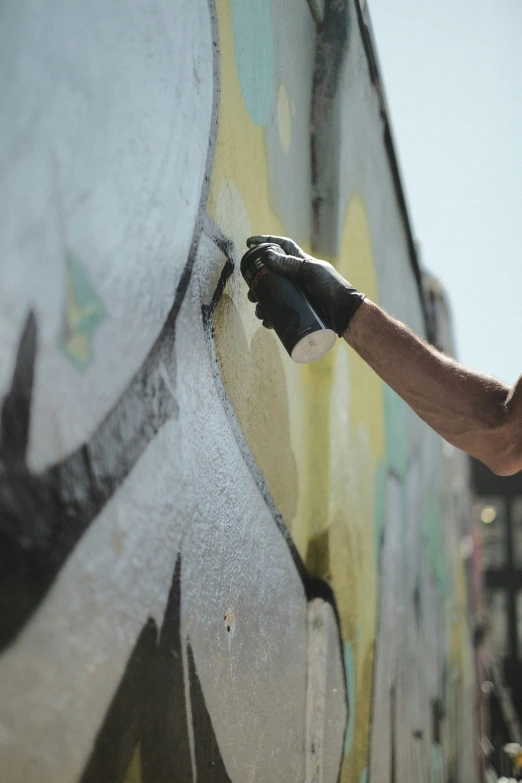 a young man is painting a wall with his hands