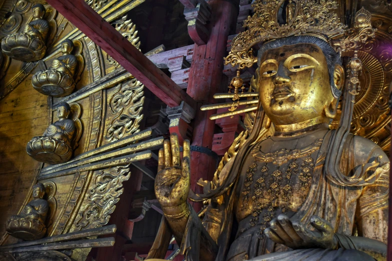 a statue of a person with his hands up to his mouth