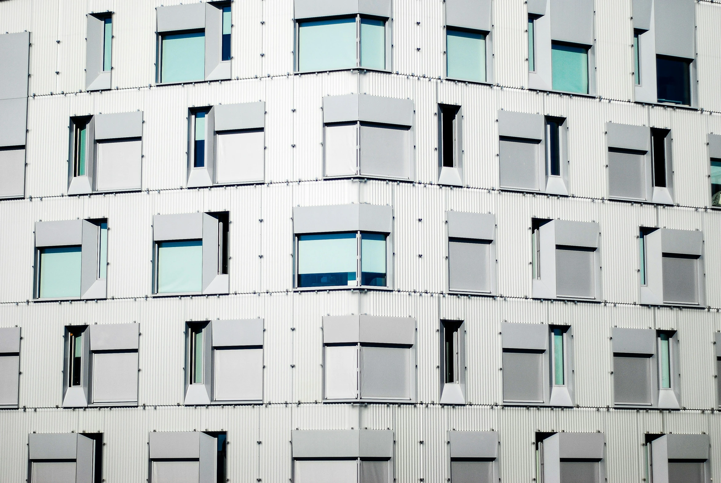 some windows on a white building in front of it