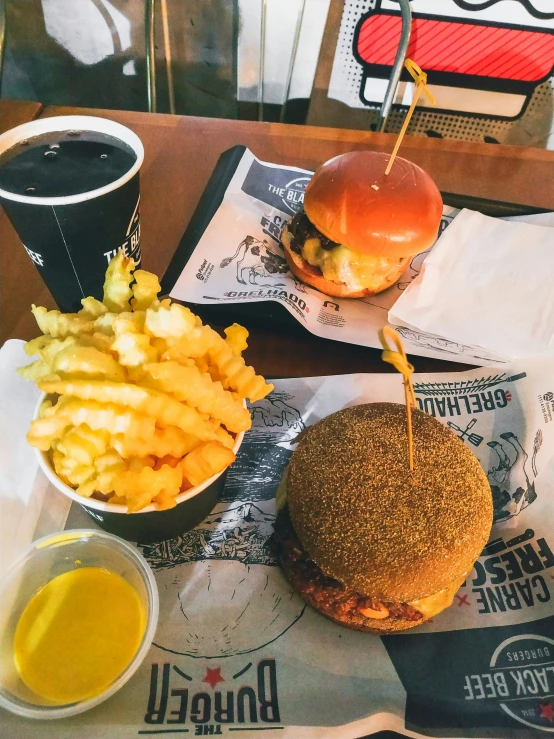 a burger and fries with french fries are served on a tray