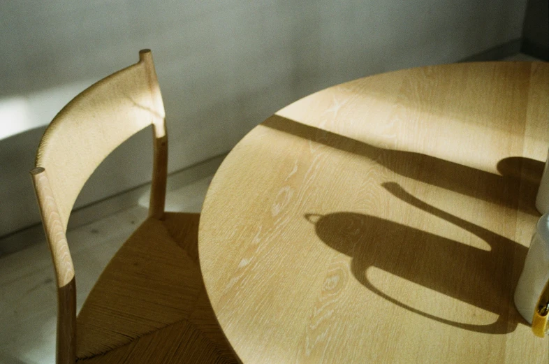 a small wooden table with two chairs near it