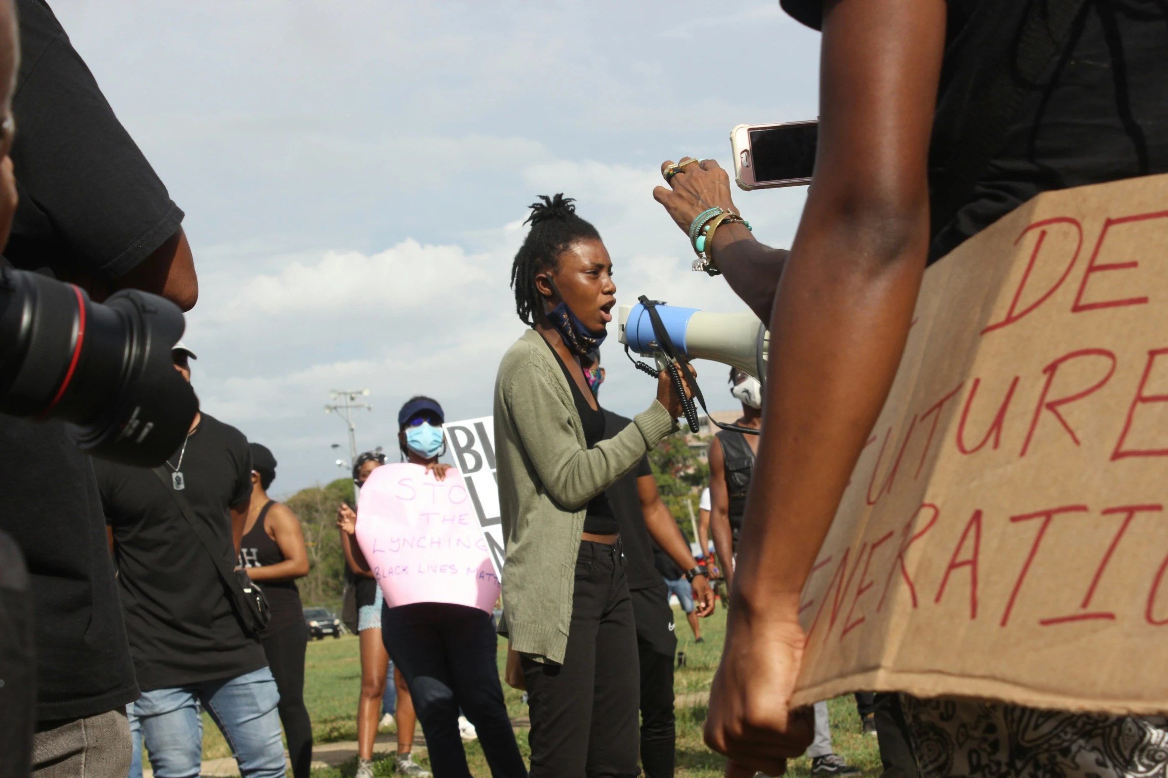 some people holding up megaphones and standing near each other