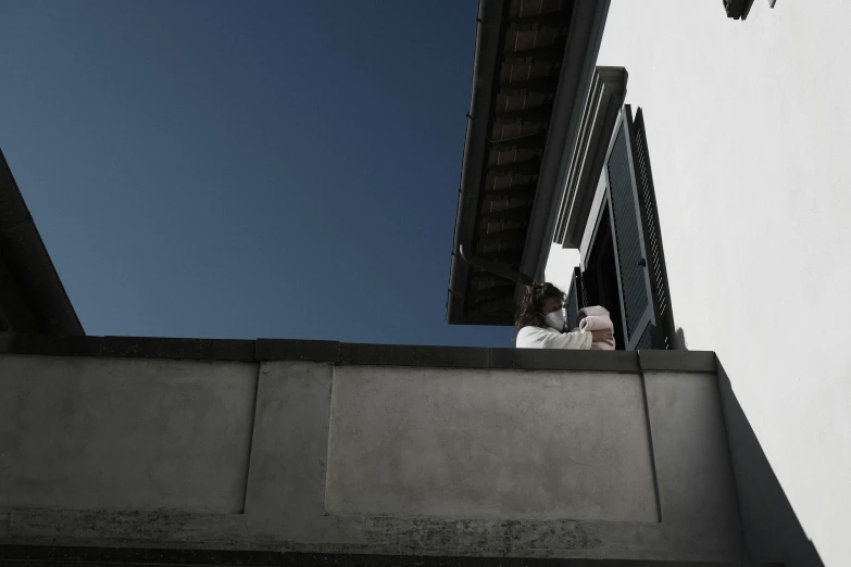 someone standing in a window looking up